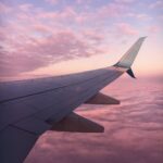 plane wing and a pink sky, Spring 2023, stuck in layover, stuck in a long layover