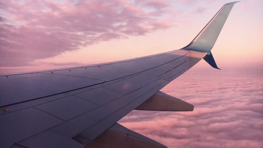 plane wing and a pink sky, Spring 2023, stuck in layover, stuck in a long layover