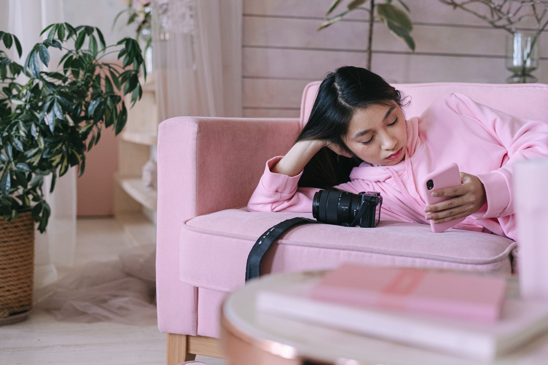 girl in pink long sleeve shirt using a phone, grief and loss, grief, coping with grief, stages of grief, things that happen after grief, things that happen after losing someone