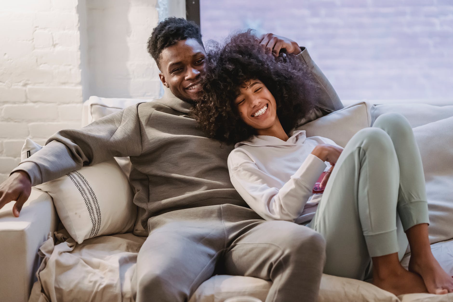 beloved african american couple cuddling and smiling on couch, dating as millennials, dating, story of David, biblical love, Godly dating