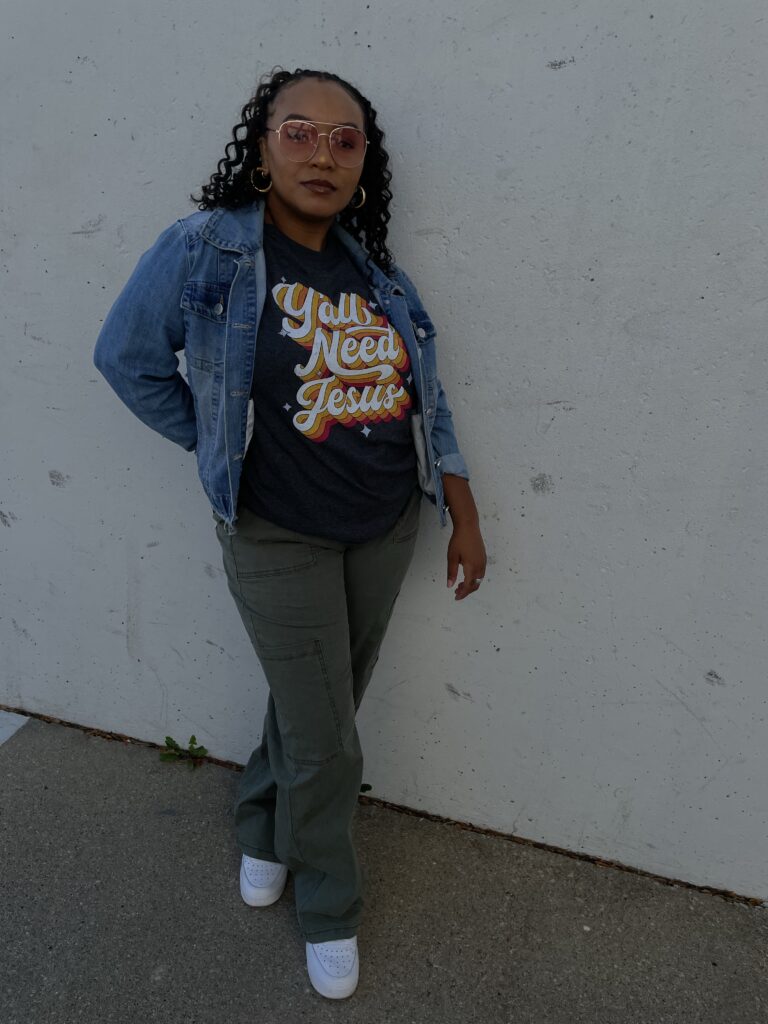 woman wearing green cargo pants, t shirt and jean jacket, standing against white background, yall need jesus, fall fashion, casual fall fashion, fall 2023 outfits, fall outfits, fall outfit ideas